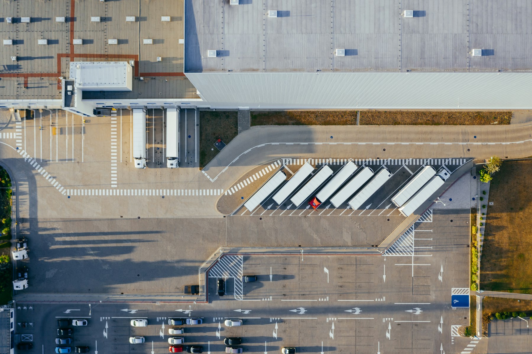 Trailers backed into a distribution center dock, seen from above