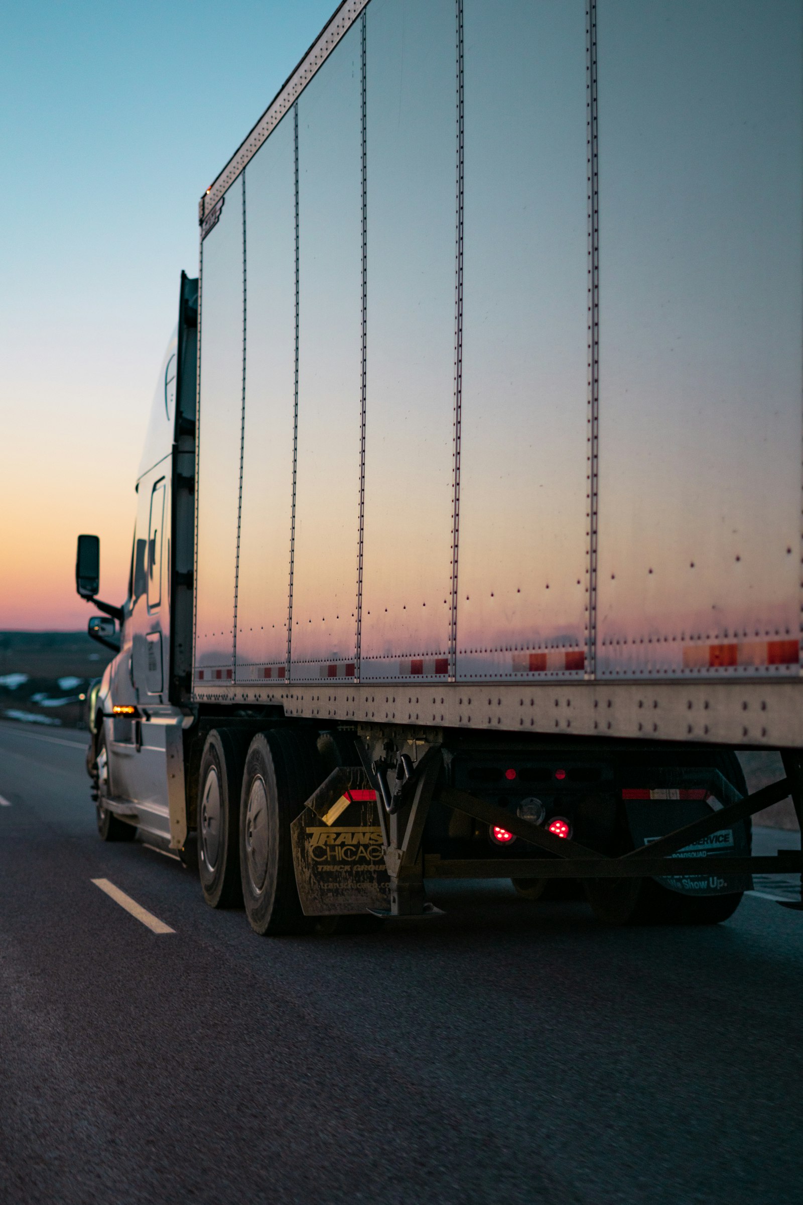 A 53-foot trailer on the highway at dusk
